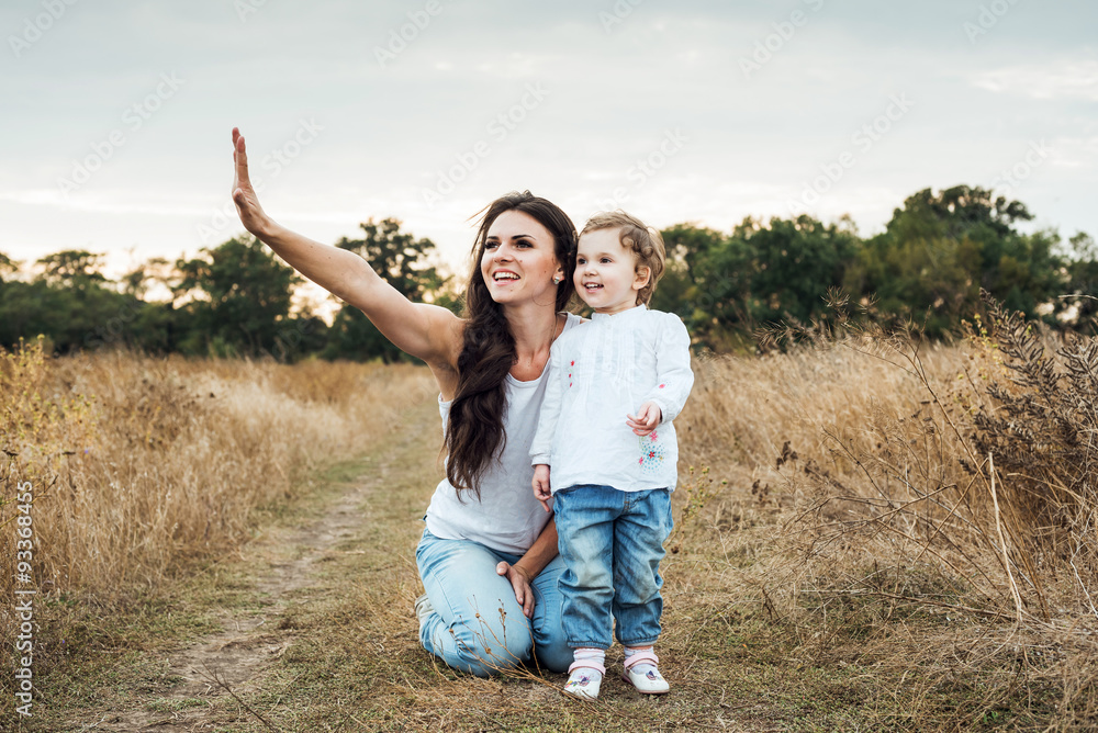 mother and daughter playing on autumn field together, loving family having fun outdoors mother and daughter playing on autumn field together, loving family having fun outdoors
