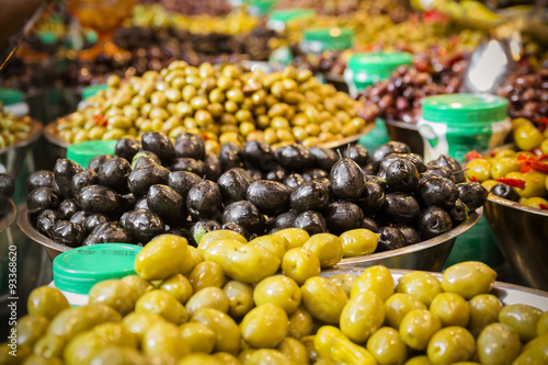 Olives at a market stall. A variety of types of olives. Green, black, Syrians and others.
