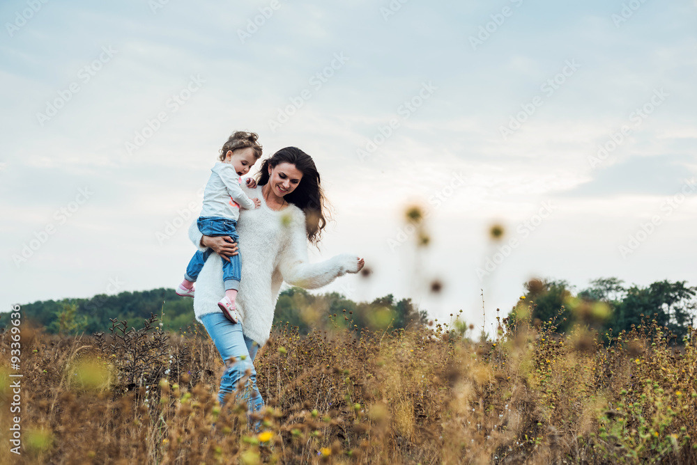 mother and daughter playing on autumn field together, loving family having fun outdoors mother and daughter playing on autumn field together, loving family having fun outdoors