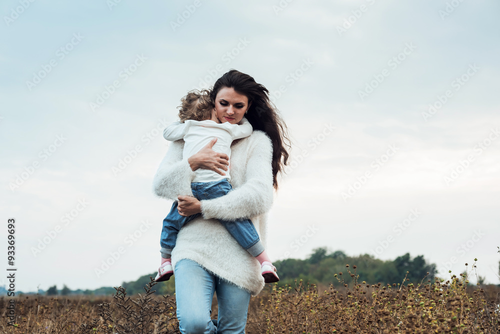 mother and daughter playing on autumn field together, loving family having fun outdoors mother and daughter playing on autumn field together, loving family having fun outdoors