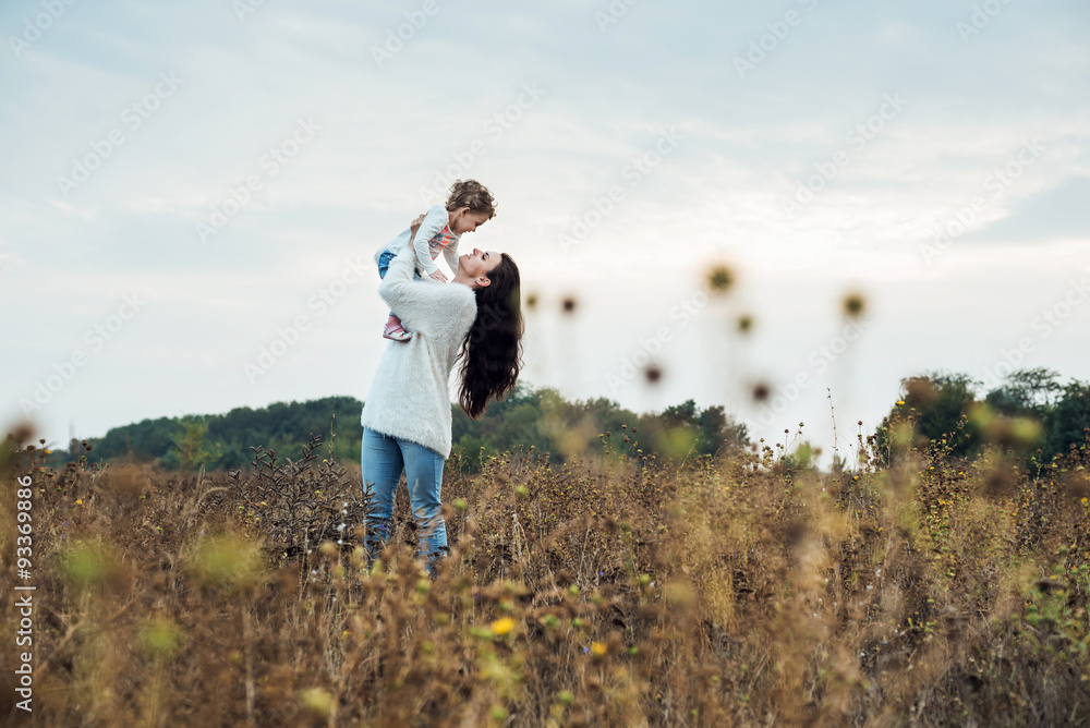 mother and daughter playing on autumn field together, loving family having fun outdoors mother and daughter playing on autumn field together, loving family having fun outdoors