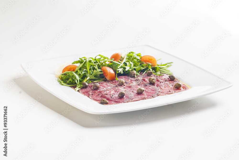 Carpaccio with parmesan cheese, arugula and capers