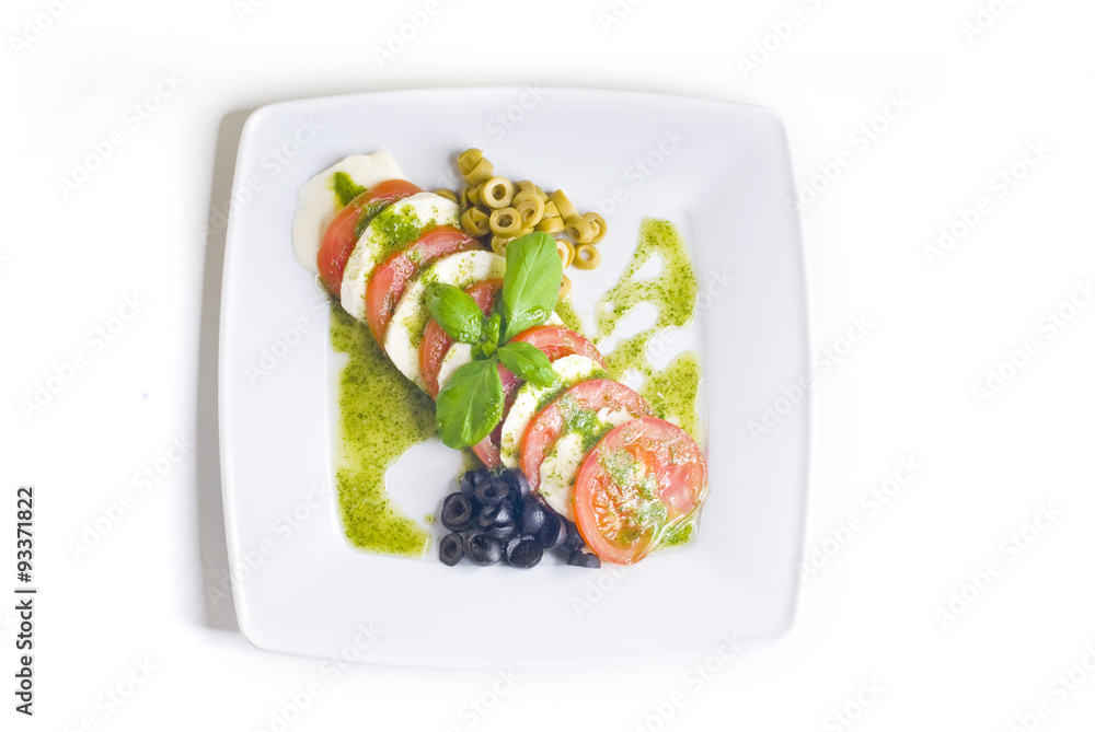 Caprese salad with tomato and mozzarella on white background