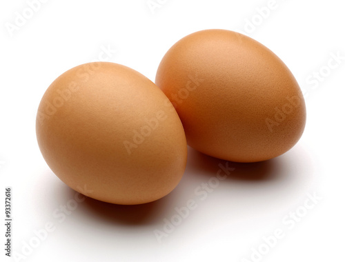 two brown eggs isolated on white