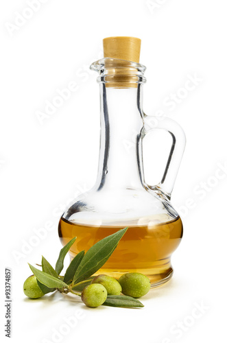 A branch of olive and olive oil in a decanter on a white backgro