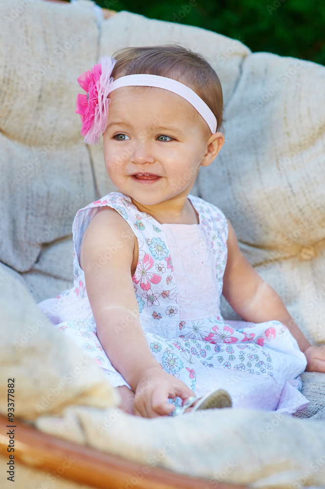 happy little girl sitting on the couch and smiling happy little girl sitting on the couch and smiling
