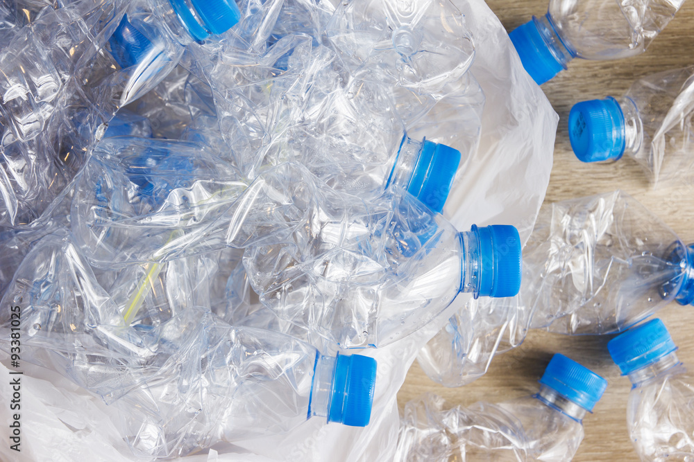 Plastic bottles in plastic bag on the wood Plastic bottles in plastic bag on the wood