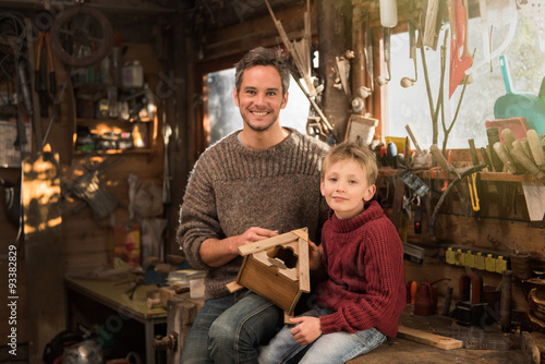 father and his little son working a rustic wooden workshop  © jackfrog