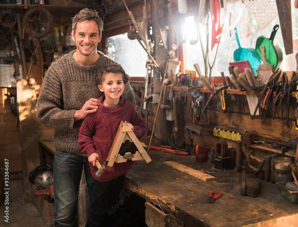 father and his little girl working a rustic wooden workshop 