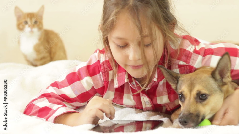 kid, red dog and an electronic tablet kid, red dog and an electronic tablet