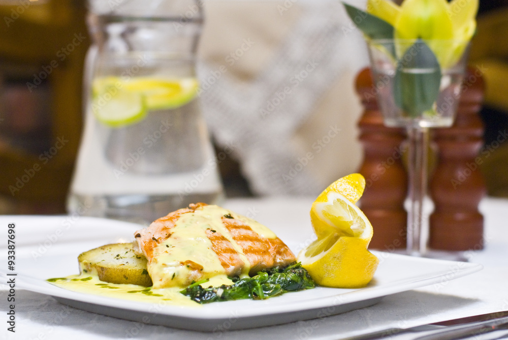 Grilled salmon with fried potatoes and spinach