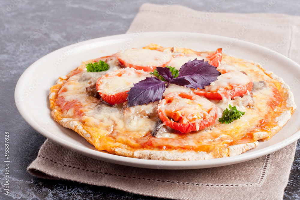 pizza with tomato sauce, cheese, basil and parsley on a plate