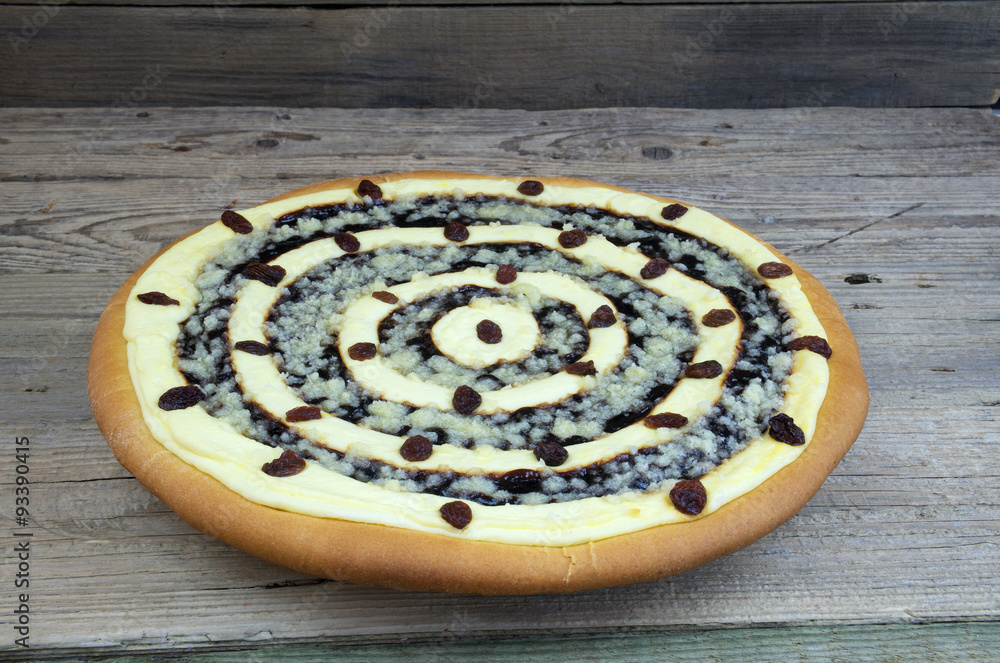 Cheesecake with poppy seeds and raisins on wooden table