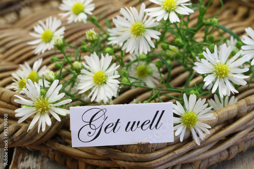 Get well card with chamomile flowers on wicker tray
