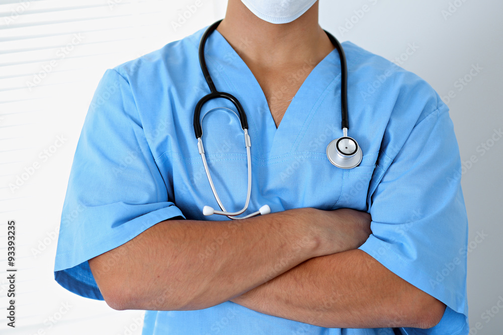 Portrait of unknown male surgeon doctor holding his stethoscope, crossed arms Portrait of unknown male surgeon doctor holding his stethoscope, crossed arms