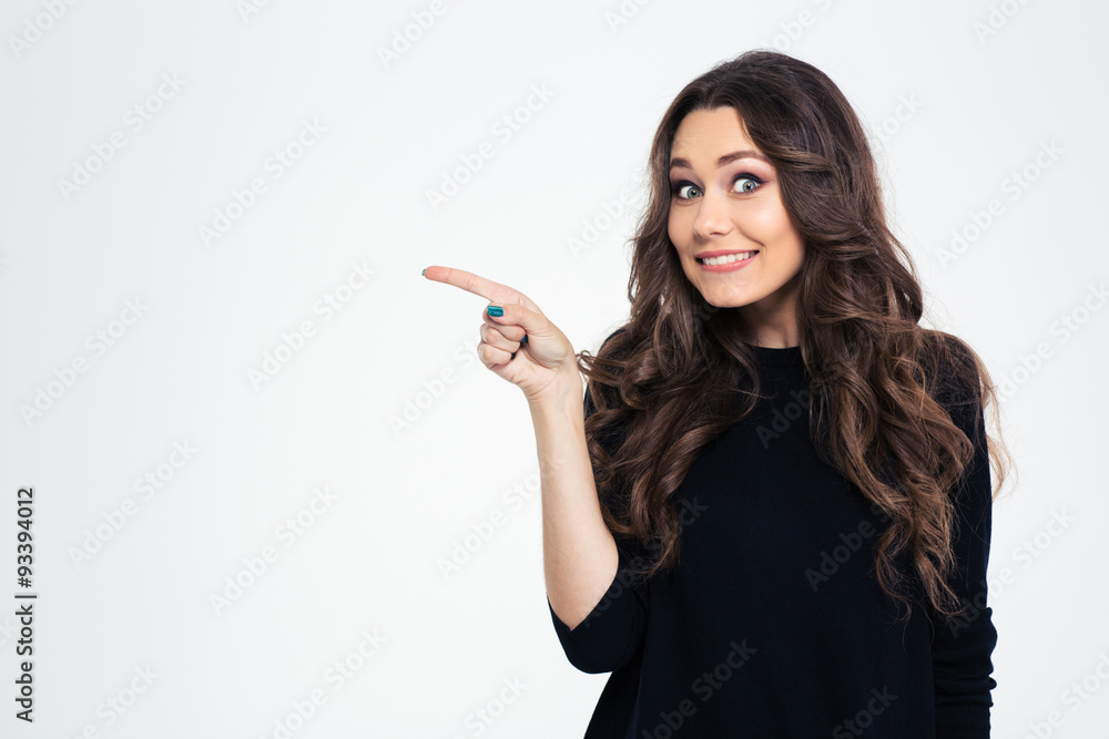 Portrait of a smiling girl pointing finger away Portrait of a smiling girl pointing finger away