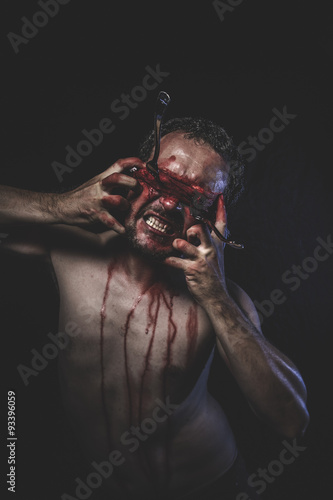 Halloween, naked man with blindfold soaked in blood