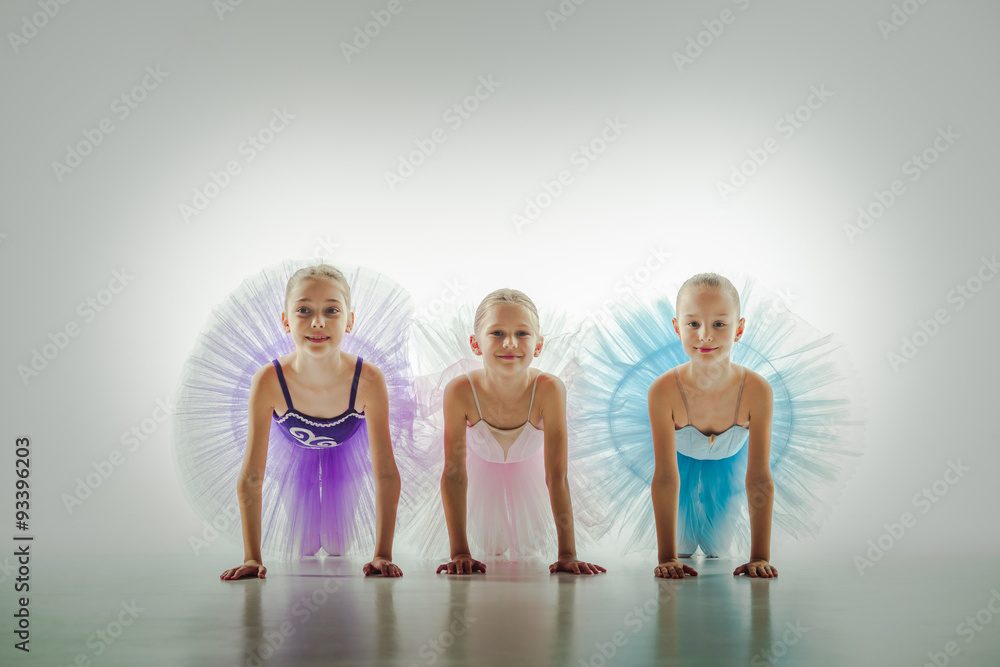 Naklejka premium Three little ballerinas in dance studio