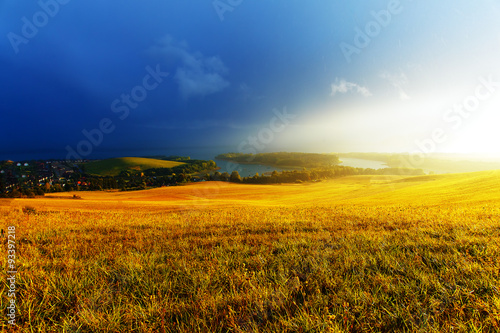 Beautiful landscape  yellow meadow and lake with mountain