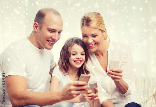 happy family with smartphones at home