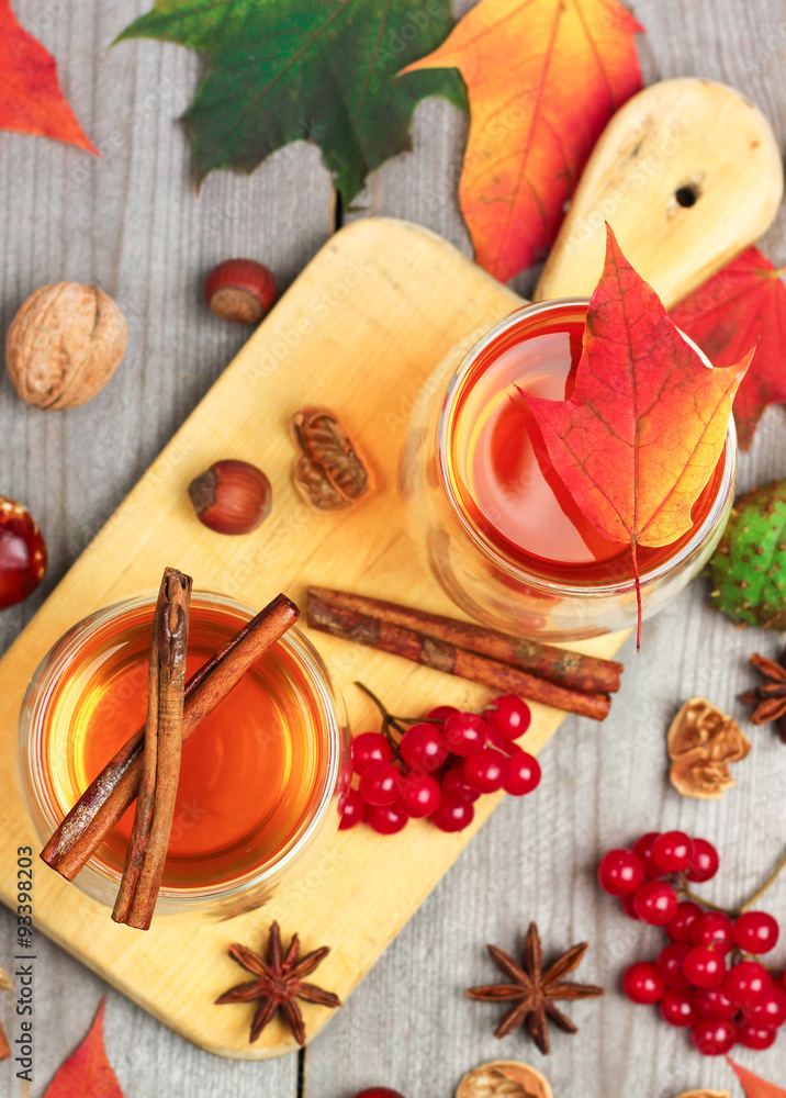 Autumn hot beverage in a glass with fruits and spices Autumn hot beverage in a glass with fruits and spices