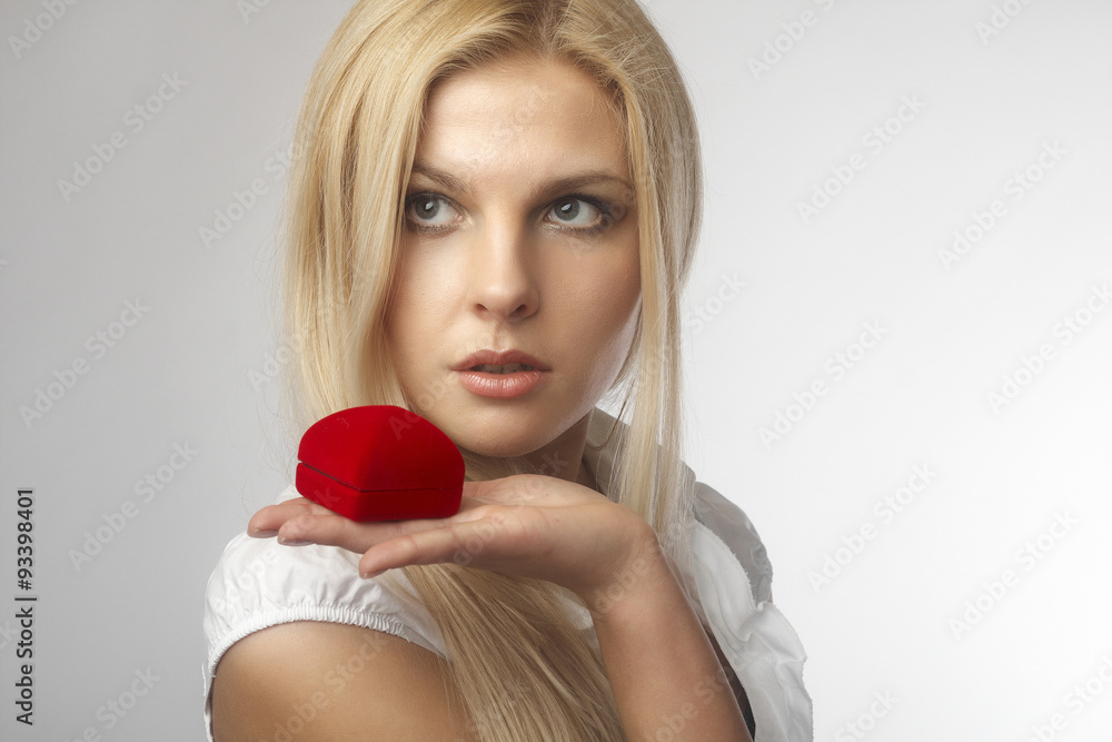 Portrait of happy young woman holding a gift Portrait of happy young woman holding a gift