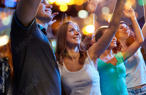 smiling friends at concert in club