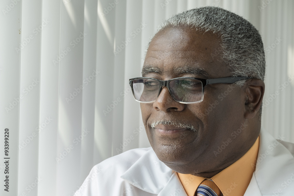 African American Doctor close up with glasses thinking African American Doctor close up with glasses thinking