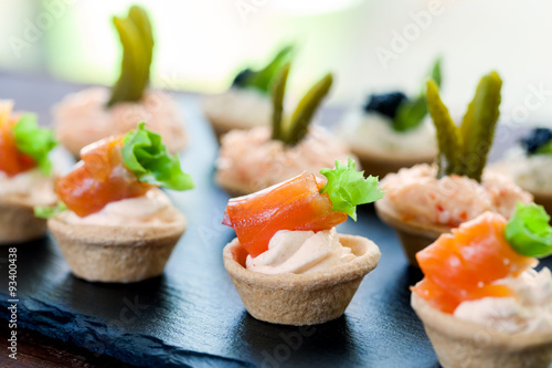 Mini puff pastry tart lets with smoked salmon filling.