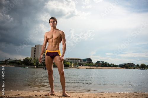 Portrait of a sporty, athletic, muscular sexy man in swimtrunks photo