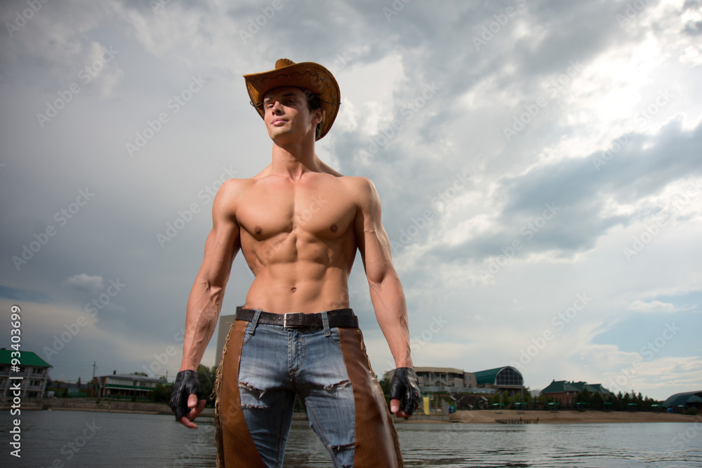 sporty, athletic, muscular sexy man in a cowboy outfit Stock Photo | Adobe  Stock