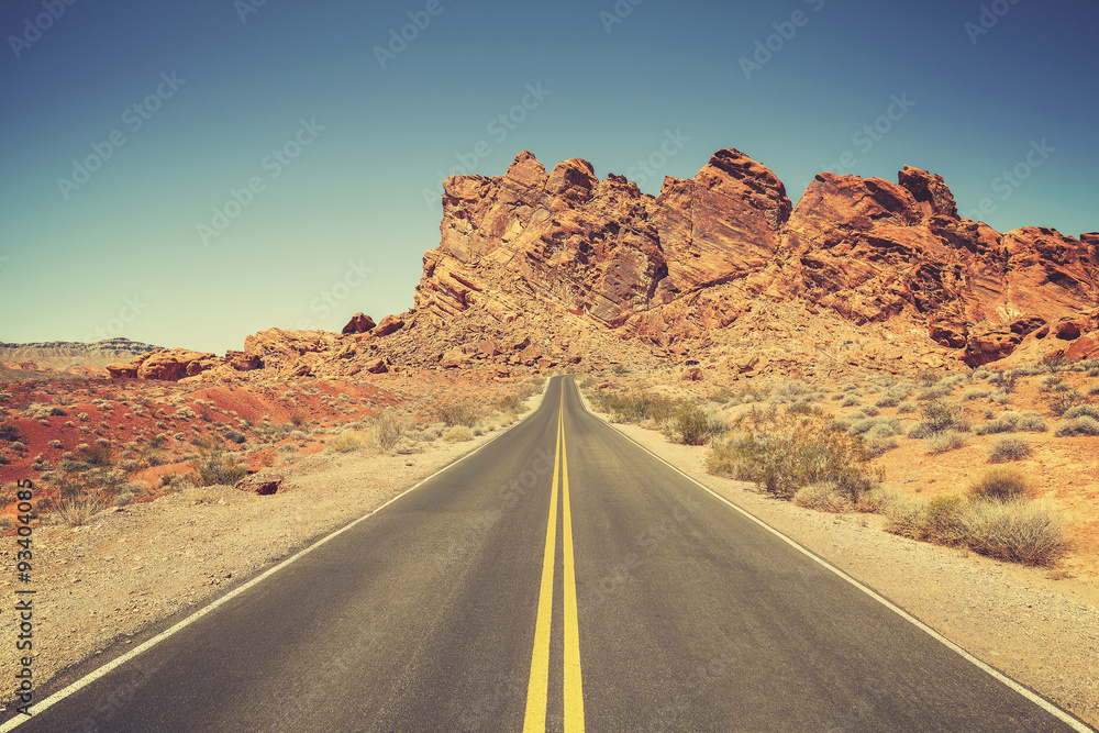 Retro stylized road through rocky desert, Nevada.