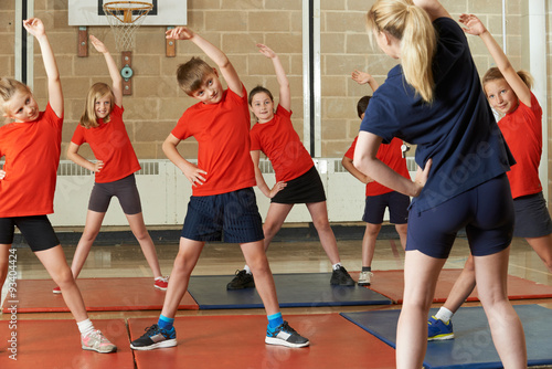 Teacher Taking Exercise Class In School Gym photo