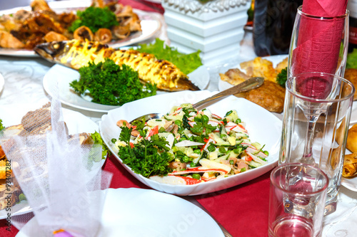 Salad, fish and other dishes on the banquet table