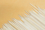 Wood stick for meatball skewers on brown paper texture background