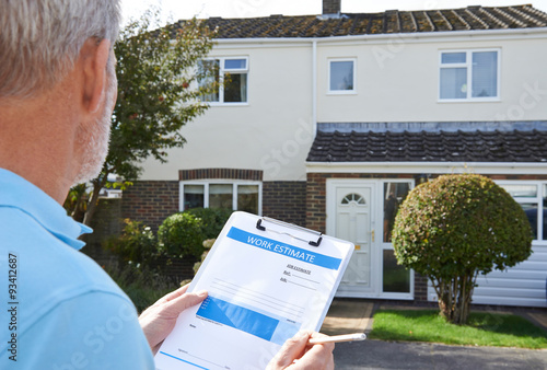 Builder Preparing Estimate For Exterior Home Improvement