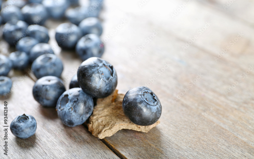 Tasty ripe blueberries on wooden table close up Tasty ripe blueberries on wooden table close up