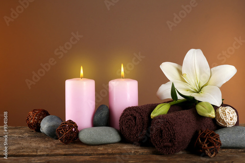 Beautiful spa composition with lily on brown background