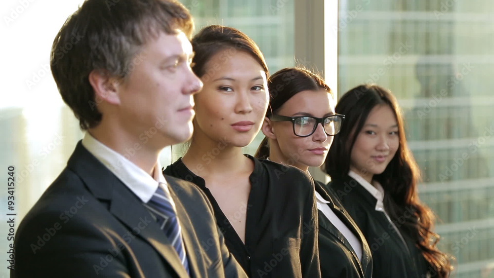 multi ethnic business team. They all look into the camera and multi ethnic business team. They all look into the camera and