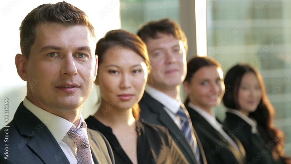 multi ethnic business team. They all look into the camera and multi ethnic business team. They all look into the camera and