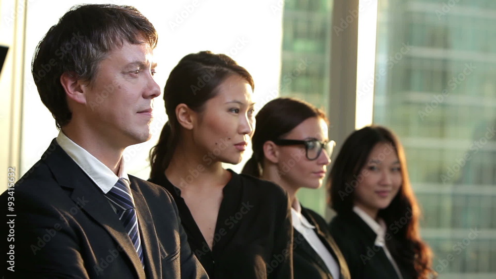 multi ethnic business team. They all look into the camera and multi ethnic business team. They all look into the camera and