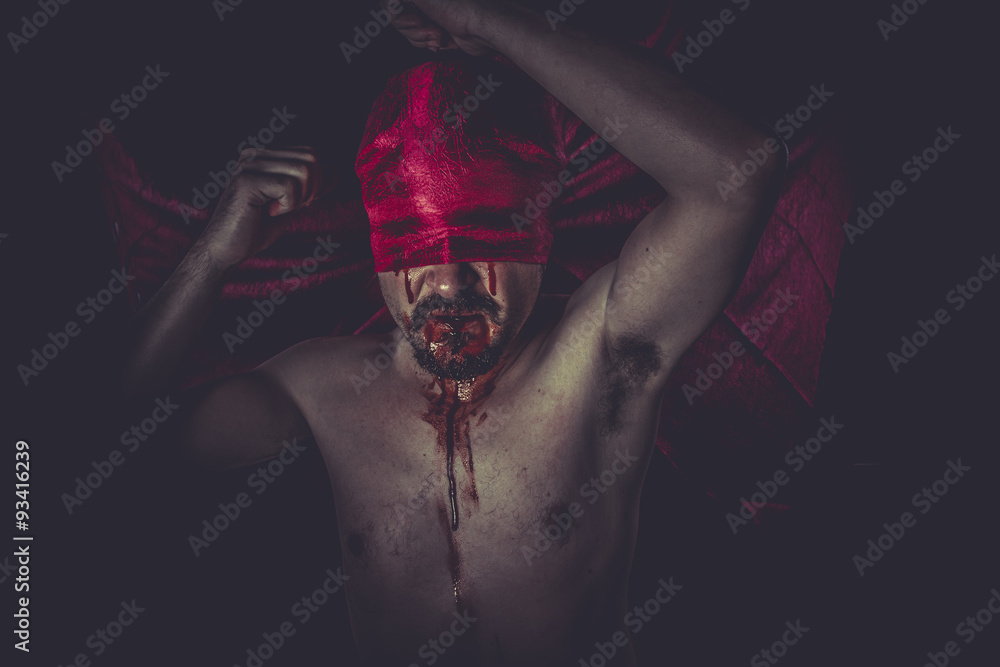 Halloween, naked man on large red cloth over his eyes