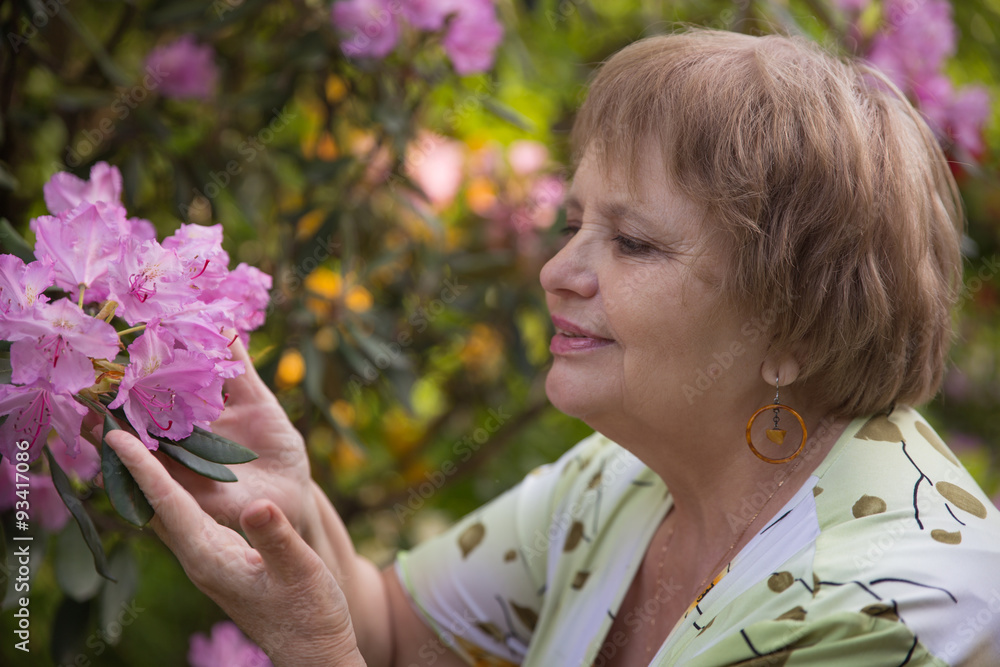Fototapeta premium Pensioner woman in blossom garden