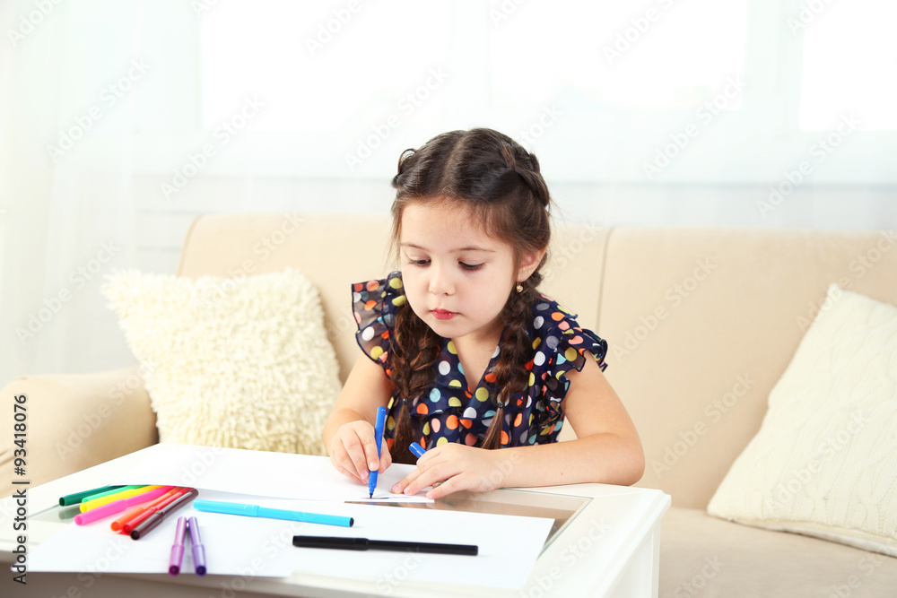 Cute little girl drawing picture on home interior background Cute little girl drawing picture on home interior background