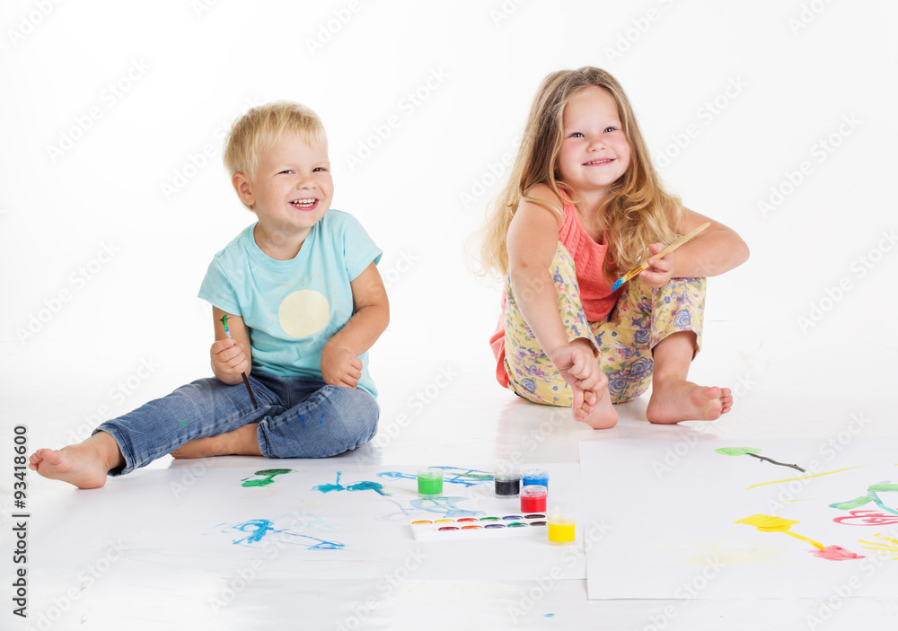 Two childs are drawing by aquarelle paints Two childs are drawing by aquarelle paints