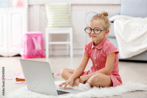 Little girl with laptop in ...