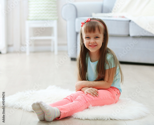 Little cute girl sitting on...