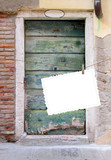 Single hanged postcard on ancient Venetian wooden door background