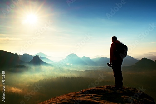 The photographer think about picture at sunset in the misty mountains photo