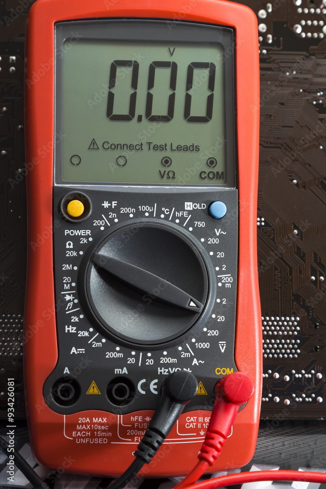 Fototapeta premium Red multimeter on motherboard background